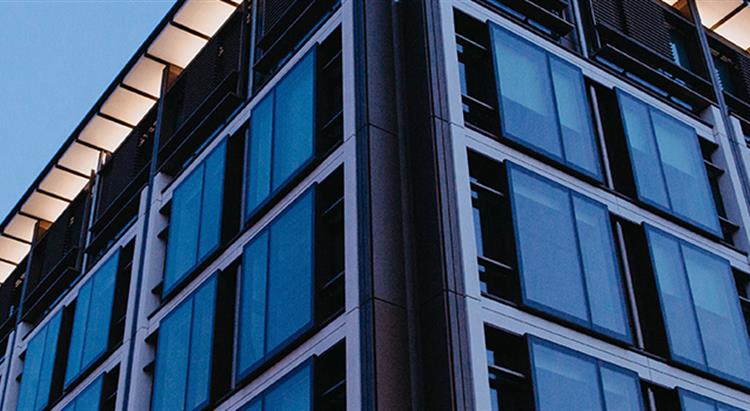 Photo of corner of building with ights on shot at dusk in blue light